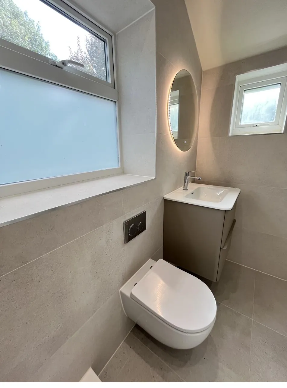 Finished ensuite toilet area with sealed floor and wall joints