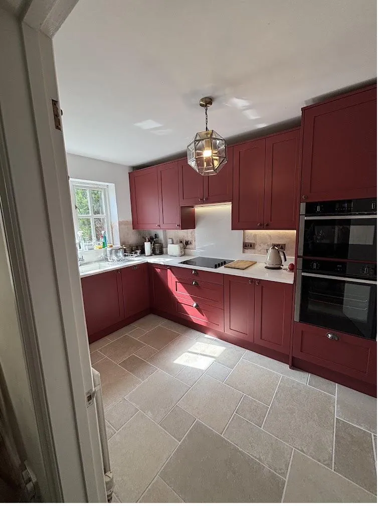 Wide view of a red shaker kitchen with sealed splashback